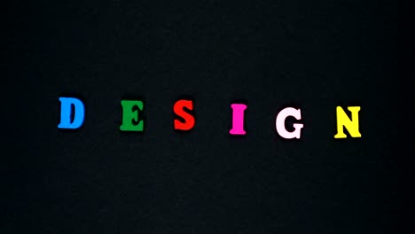 word "design" formed of wooden multicolored letters. colorful words loop.