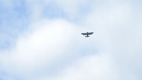 Slow-motion-low-angle-view-shot-of-sesquiplane-biplane-airplane-flying-across-the-overcast-sky