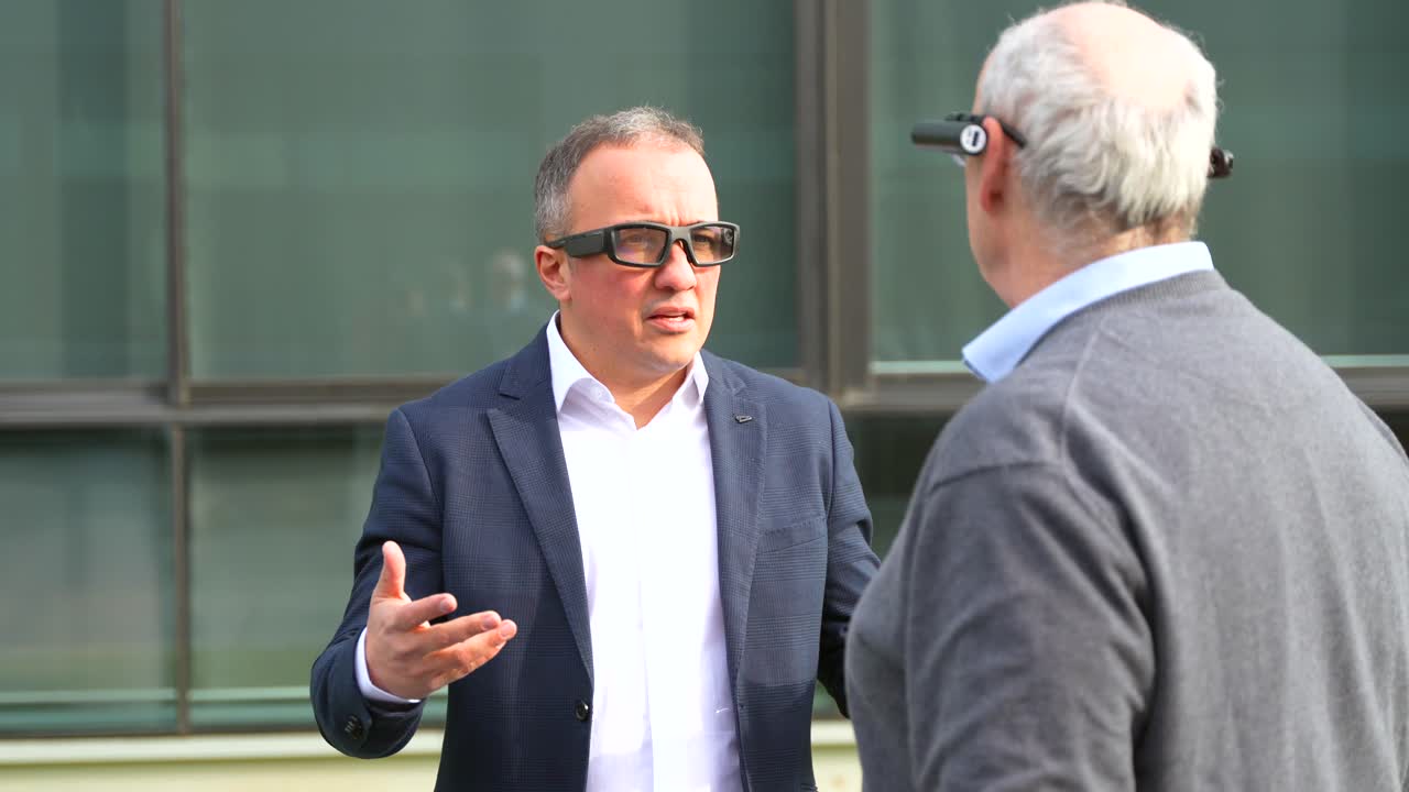 Two men discussing business with AR glasses