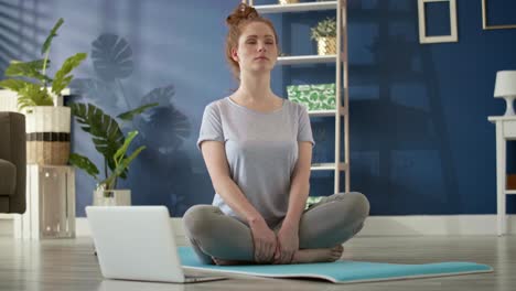 tracking left video of  woman meditating  at home