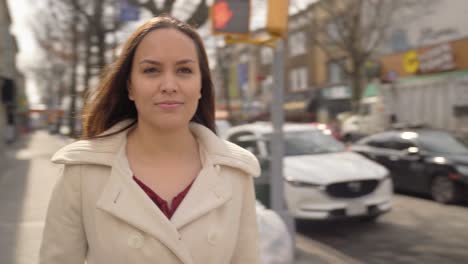 woman hopeful taking a deep breath outside on the street