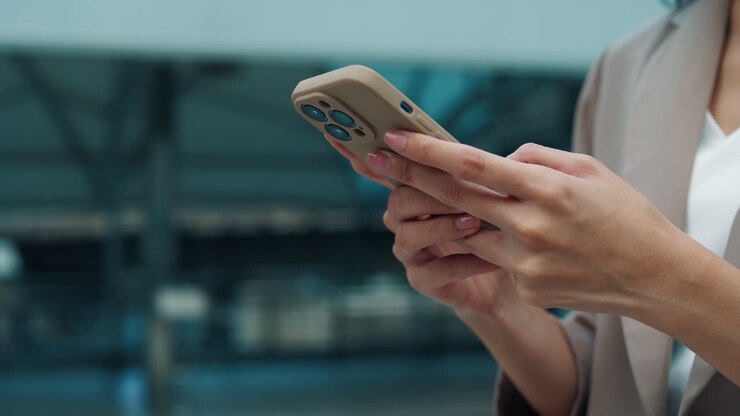 Frau nutzt Smartphone am Flughafen