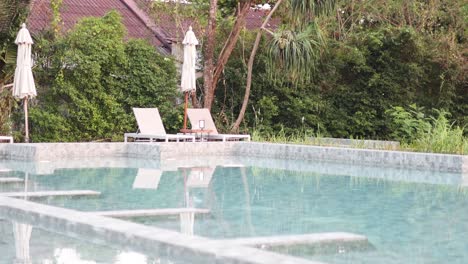 person diving into a tranquil swimming pool