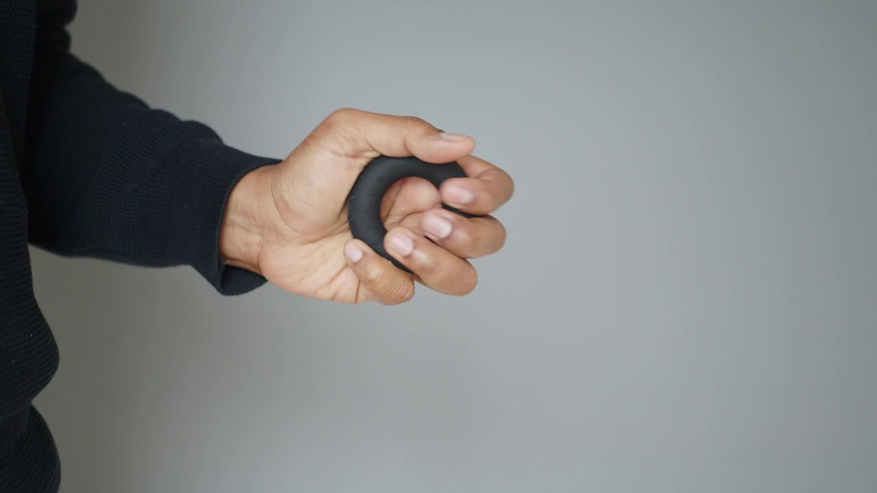 Person Exercising Hand with Grip Strength Ring