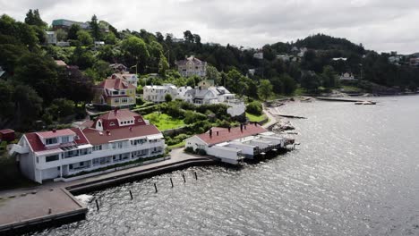 traditional swedish bathhouse by the sea in ljungskile with surrounding homes, aerial view