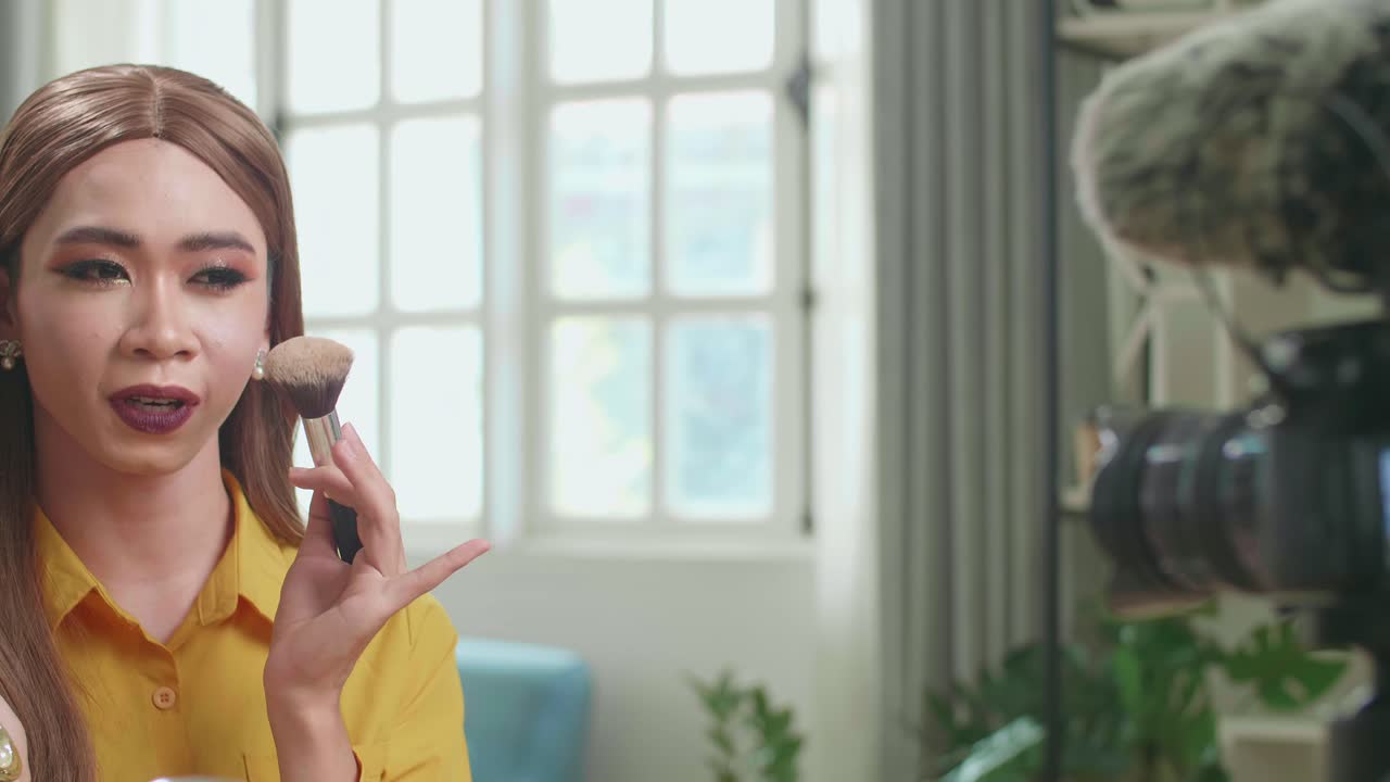 Influencer Young Transgender Woman Blogger Talks About Makeup. Blogger Talks Facial Beauty Treatments. Vlogger Broadcasts How To Use Of Cosmetic In Home Studio