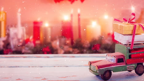 model car with presents on its roof and blurred background of candles combined with falling snow