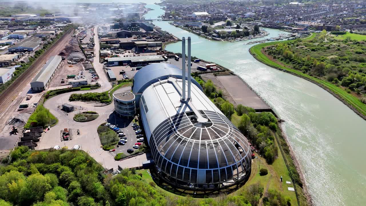 Stunning aerial drone footage of Newhaven ERF, an eco-friendly, modern facility converting non-recyclable waste into green energy for the National Grid. Set by the River Ouse, amid lush gardens.