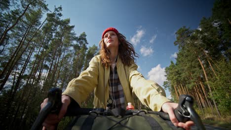 woman cycling through the forest