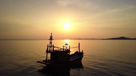 fishing boat at sea on sunset background