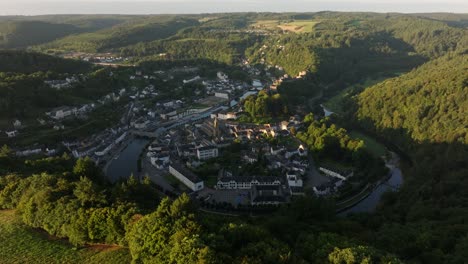 aerial view of a town in a valley surrounded by forest