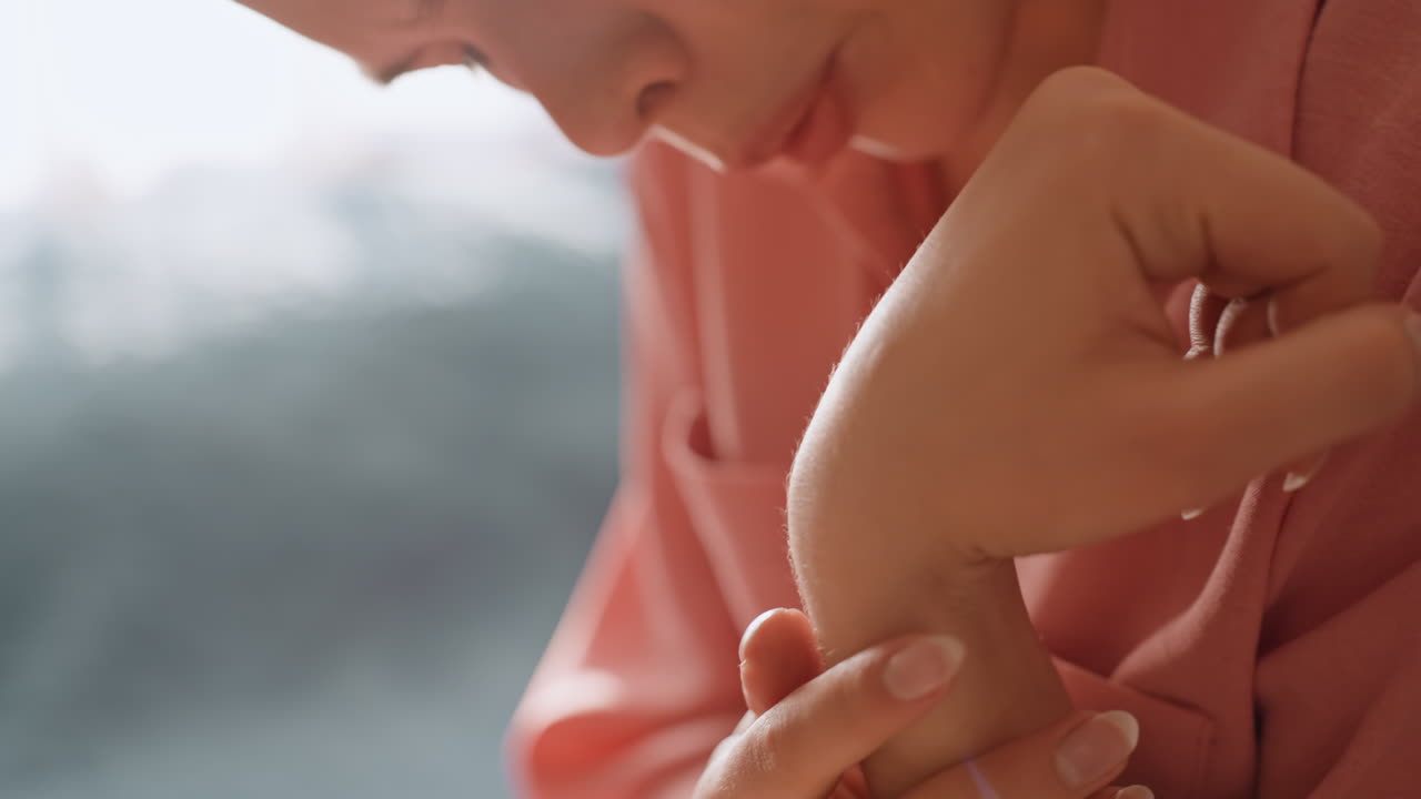 Woman Gently Massages Sore Wrist, Woman Soothing Her Wrist With Tender Care During Relaxation, Woman Uses Gentle Fingers To Ease Discomfort In Her Injured Wrist During Peaceful Selfcare Moment
