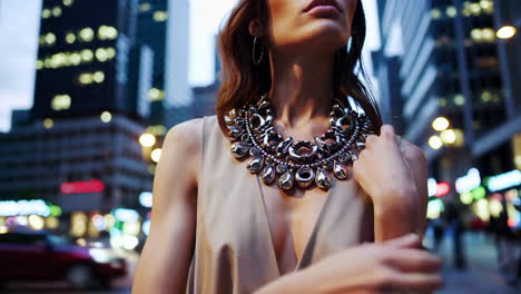 elegant woman in city at night