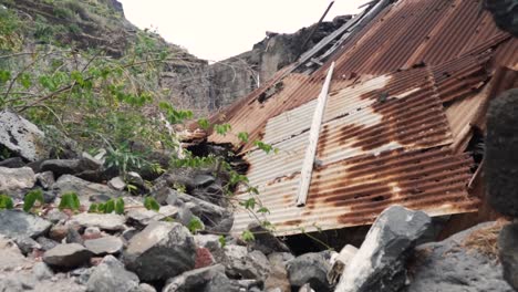 ruined building with damaged corrugated metal roof