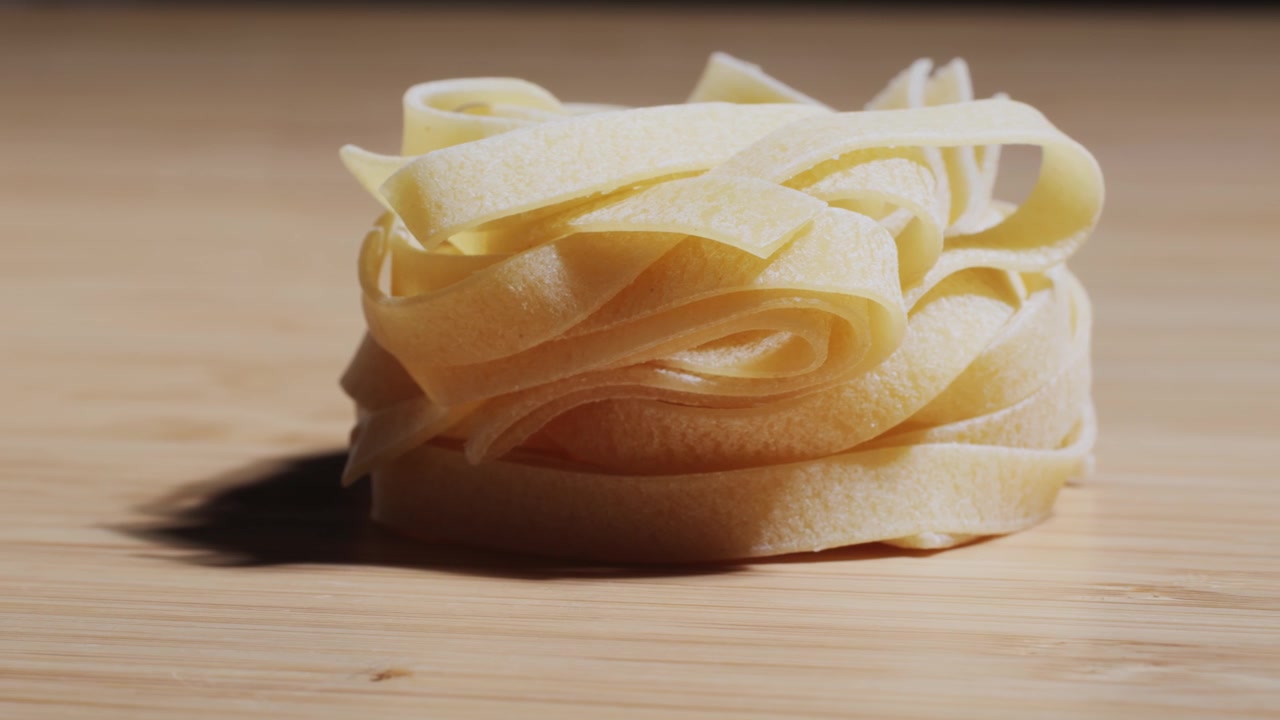 Nidi di Tagliatelle Crude su una Superficie di Legno