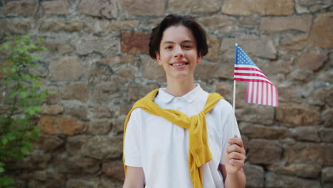 teenager holding american flag