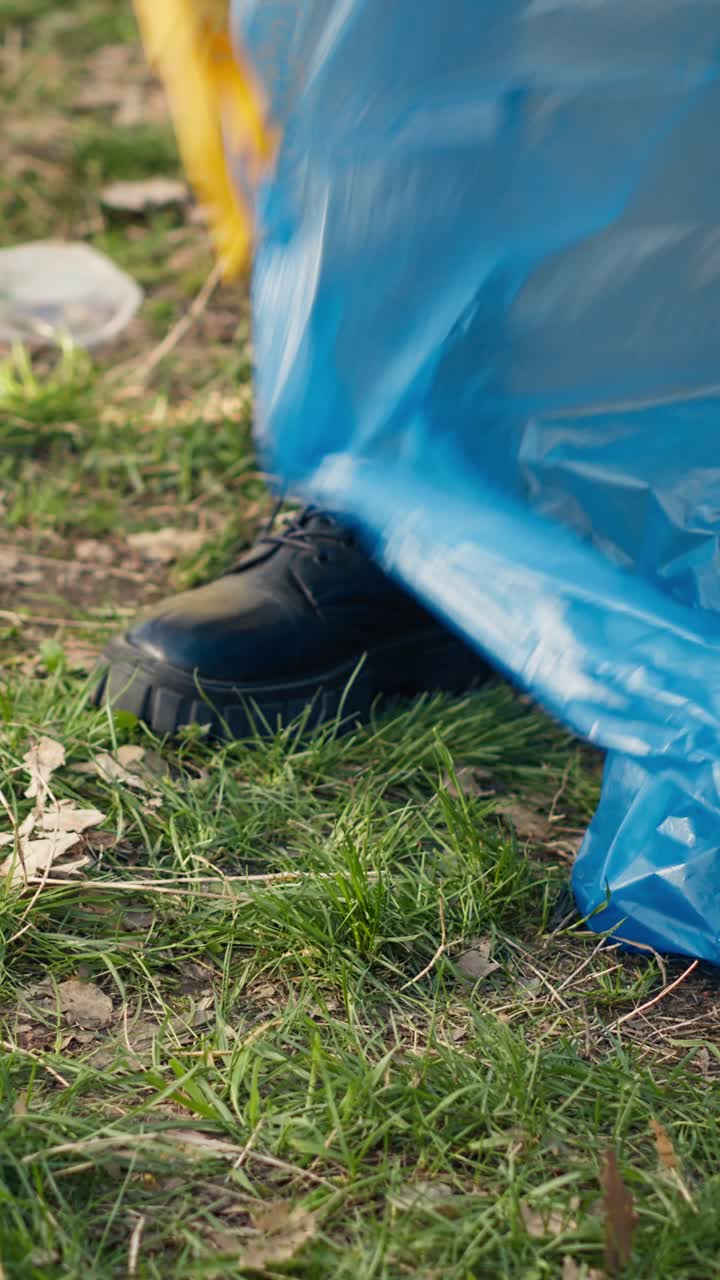 Person Using Grabber Tool to Pick Up Litter from Grass