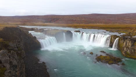 slow orbiting shot of the beautiful godafoss waterfall in the iceland countryside