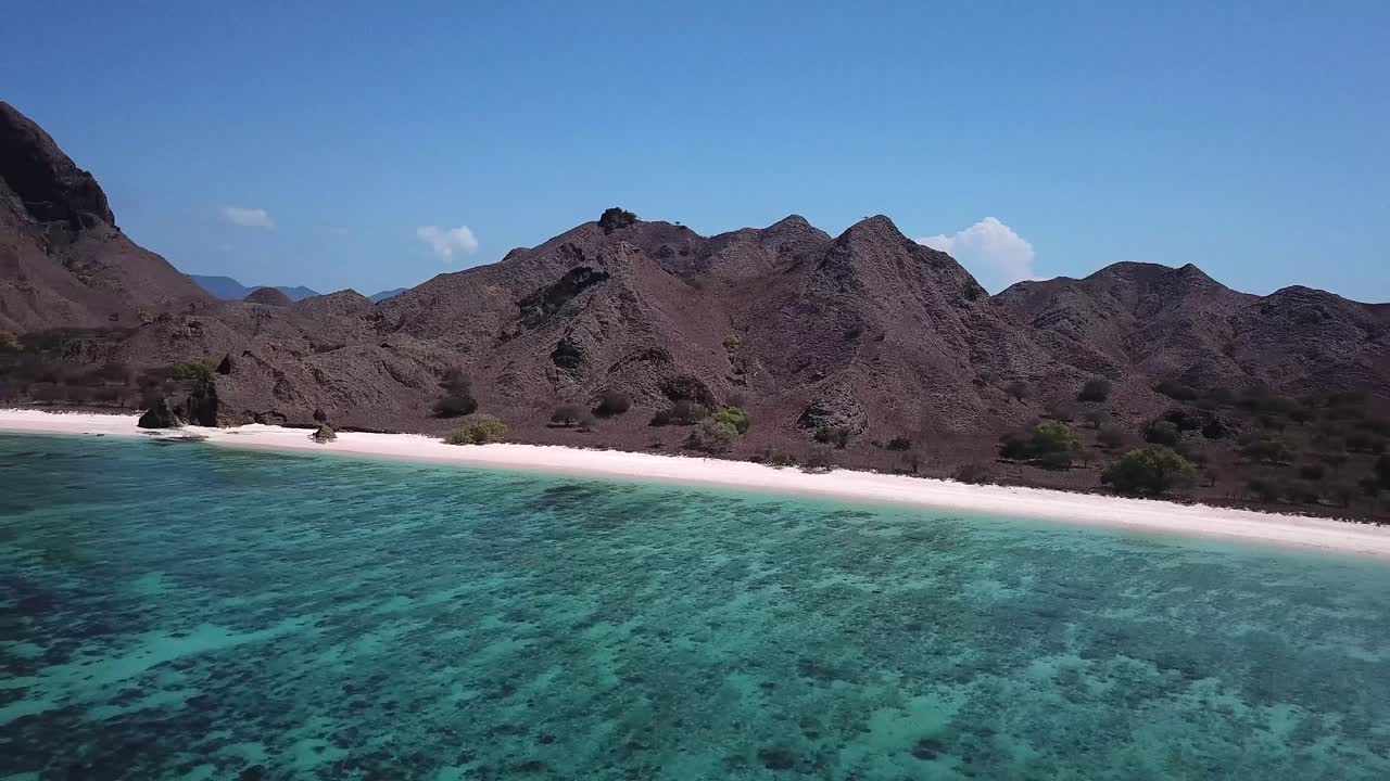Magnificent drone shot of a deserted island in West Nusa Tenggara, Indonesia. Paradise Beach view. Beautiful travel destination.