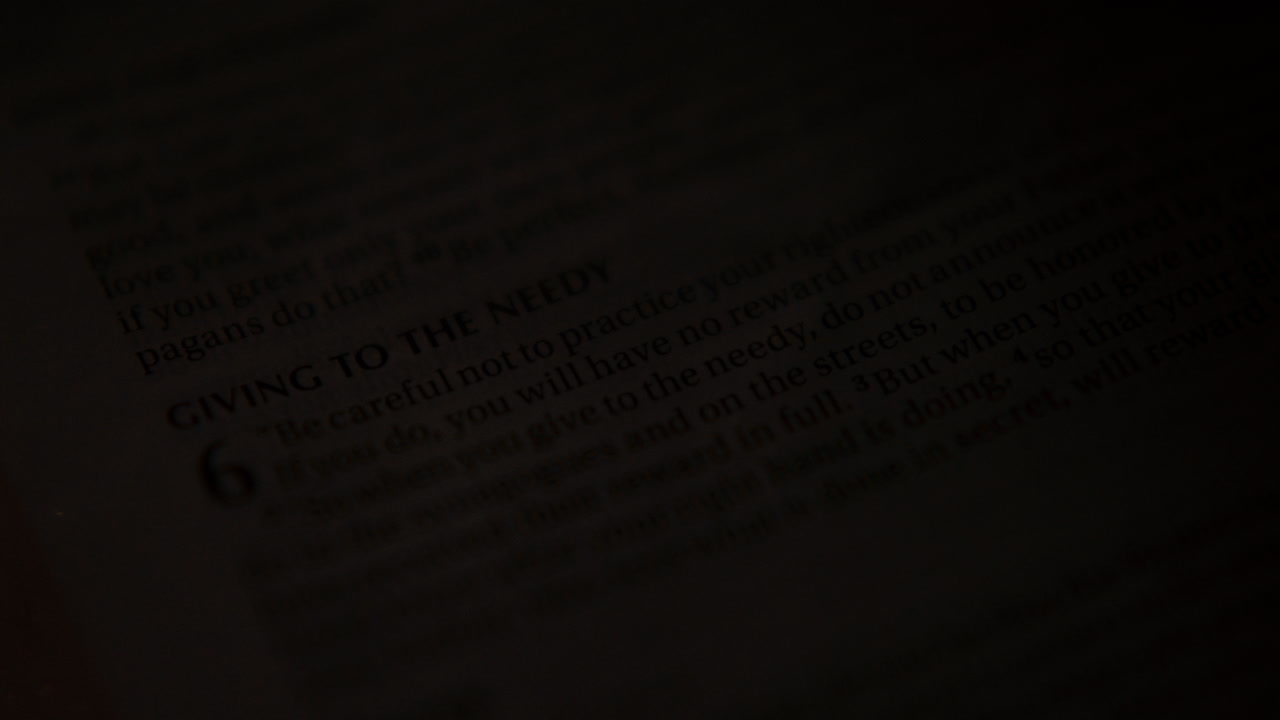 Closeup of Bible Page Discussing Charity