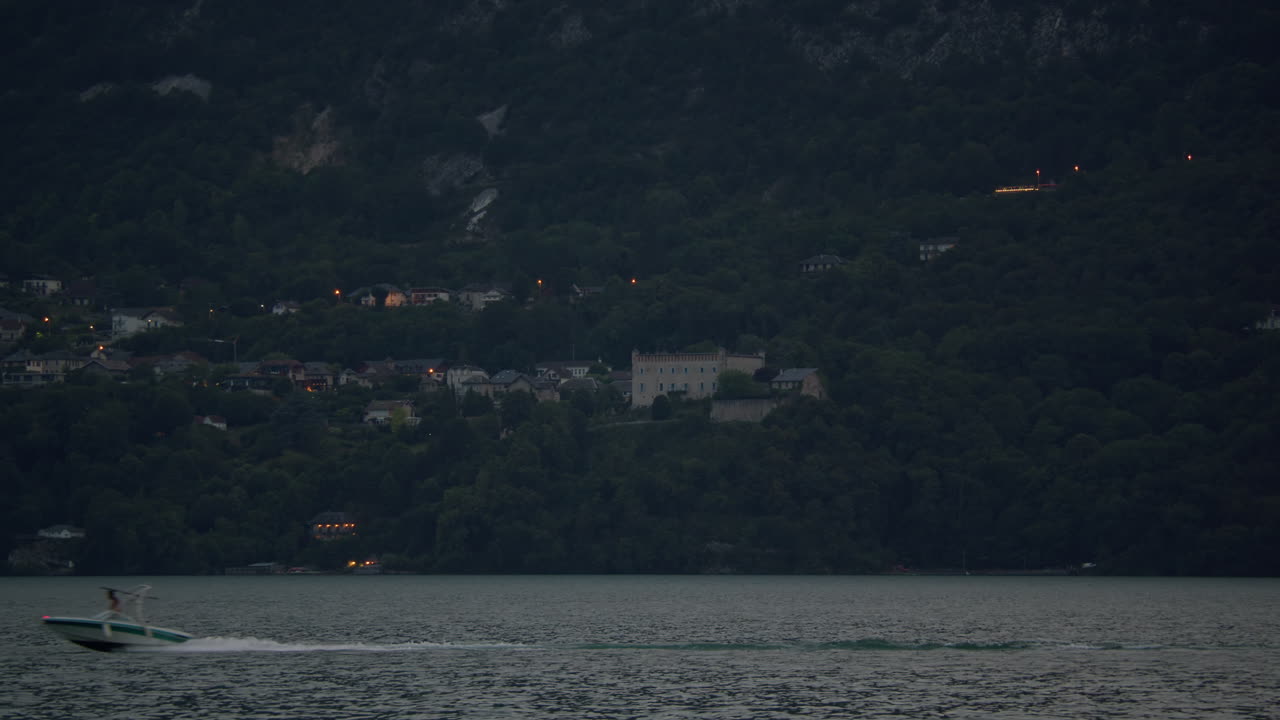호수 의 밤 의 전망 은 보트 와 언덕 의 집 들 을 가지고 있다
