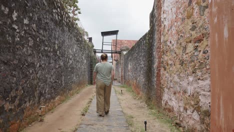 A-Woman-Is-Walking-At-The-Historic-Site-Of-Con-Dao-Prison-In-Ba-Ria-Vung-Tau,-Vietnam