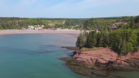 drone shot on a beautiful sunny day of the popular st martins cave located on the bay of fundy, revealing the beach in the province of new brunswick in canada shot in 4k during a hot summer day