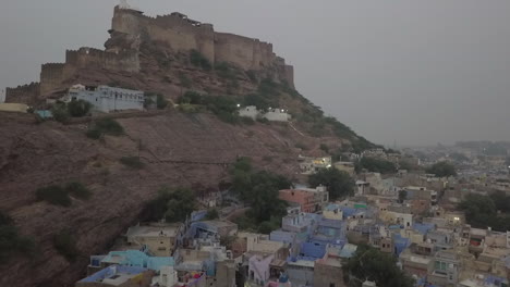 mañana neblinosa enfoques aéreos de jodhpur enorme fuerte de mehrangarh en la cima de una colina