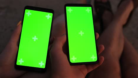 pov male and female hands holding smartphones with empty screen