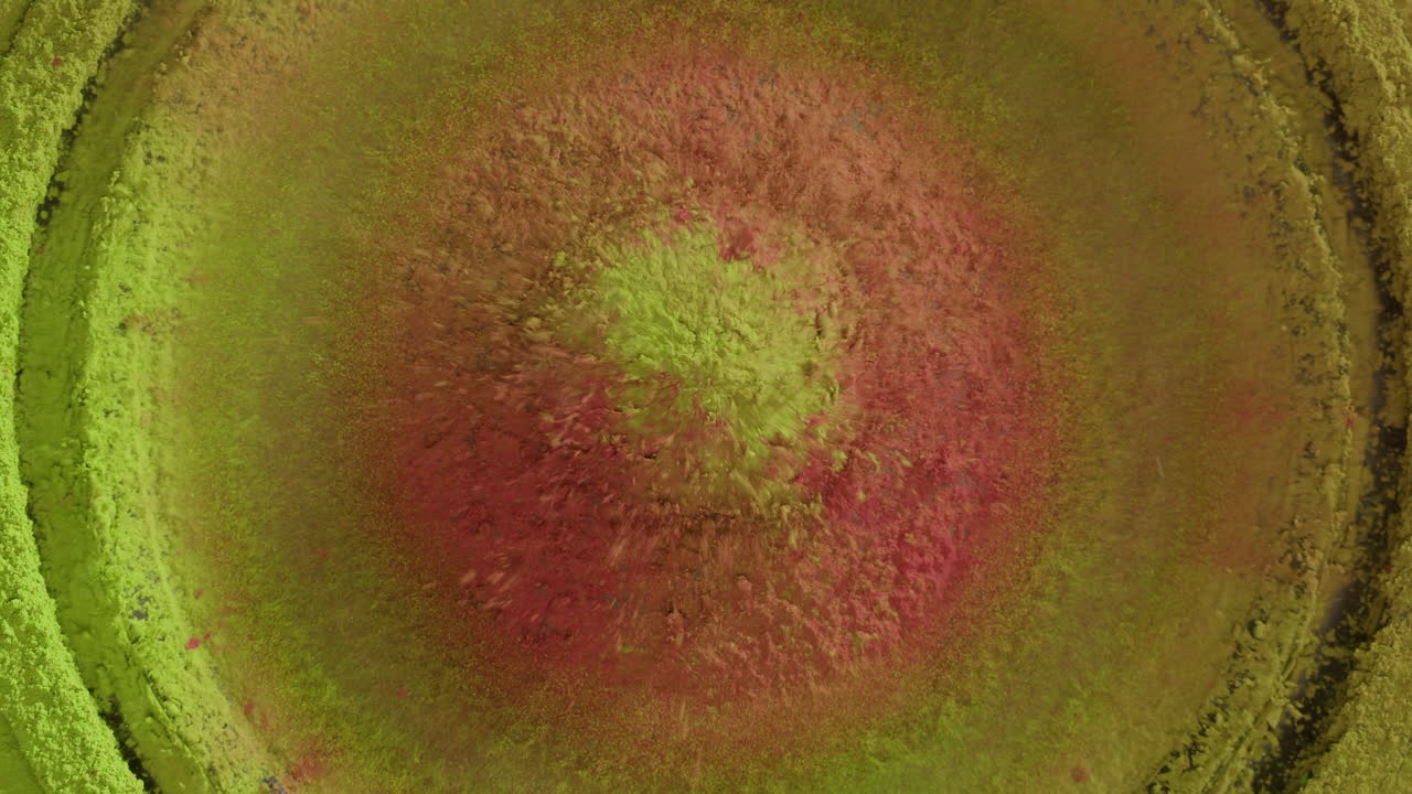 Vibrant Pink and Green Powder Vibrating and Spreading in Abstract Motion