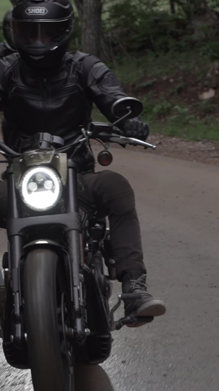 Man Riding a Motorcycle on a Country Road