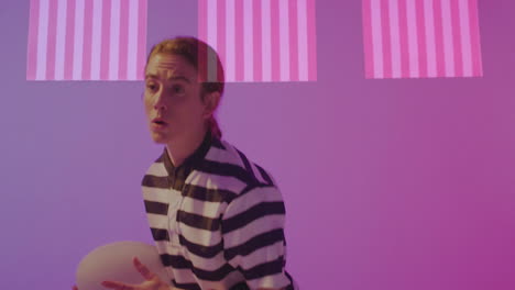 wearing striped shirt, person standing with pink and purple animation background