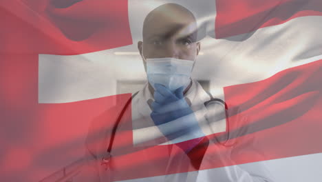 animation of flag of switzerland waving over doctor wearing face