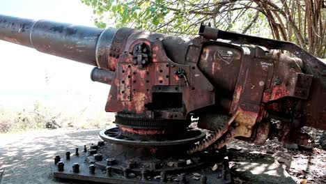 huge rusty steel world war cannon on the island of moorea in the south pacific