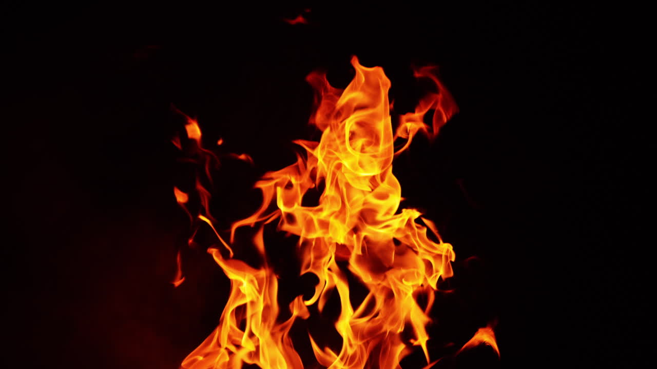 Fire tongues rising into the air. Bonfire isolated on the black backdrop. Close up.