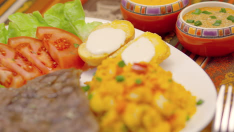 meat steak with corn tomatoes, lettuce and potatoes