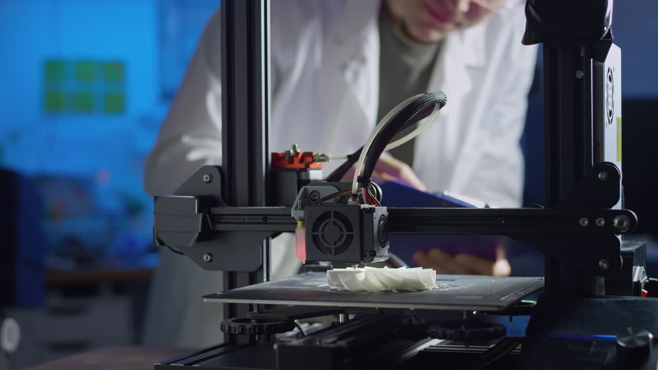 Professional engineer adjusts settings of a 3d printer while producing prototypes in a modern