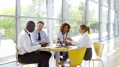 business team having meeting around table in modern office