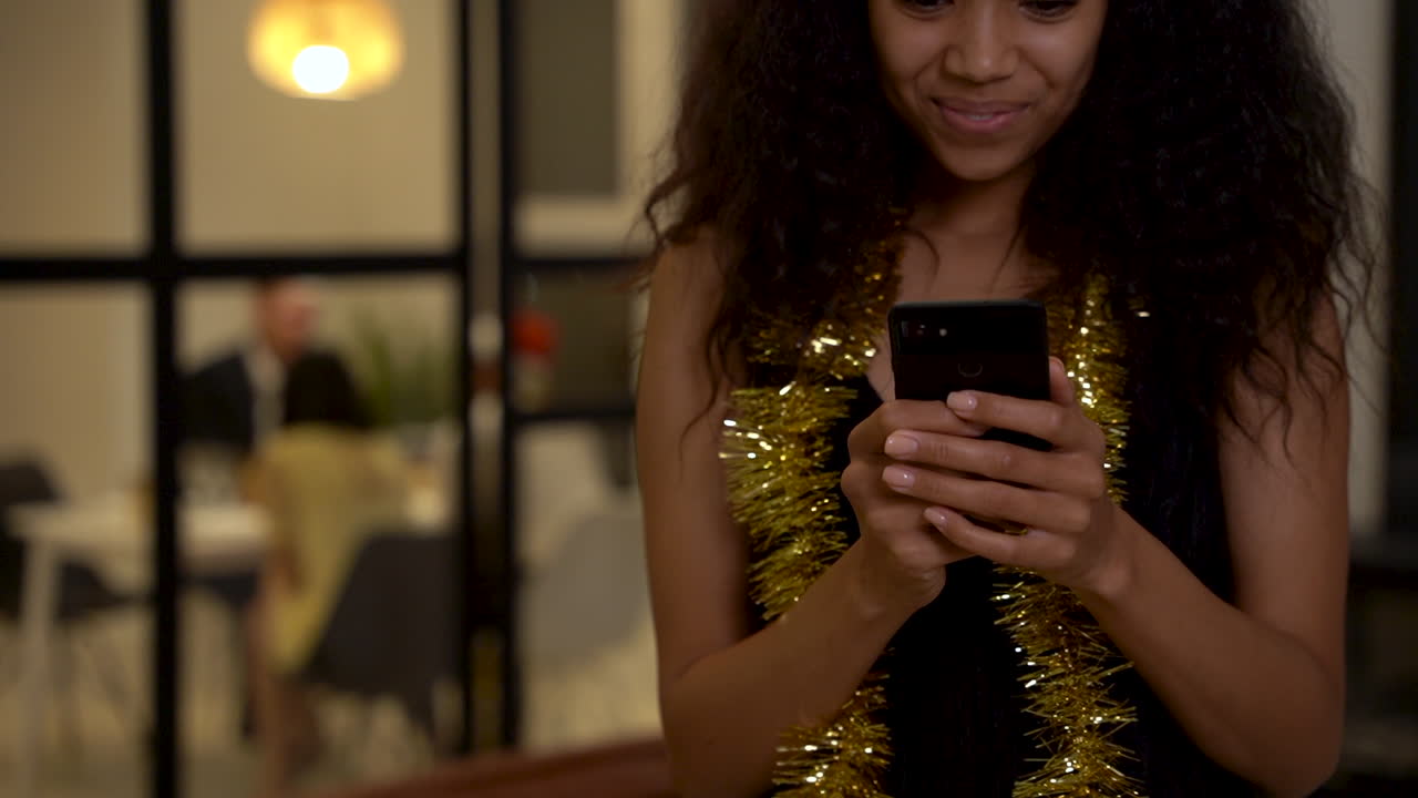 Black Girl Using A Phone In A Party At Home