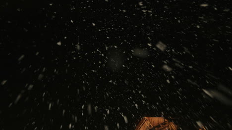 snowy night at wooden houses