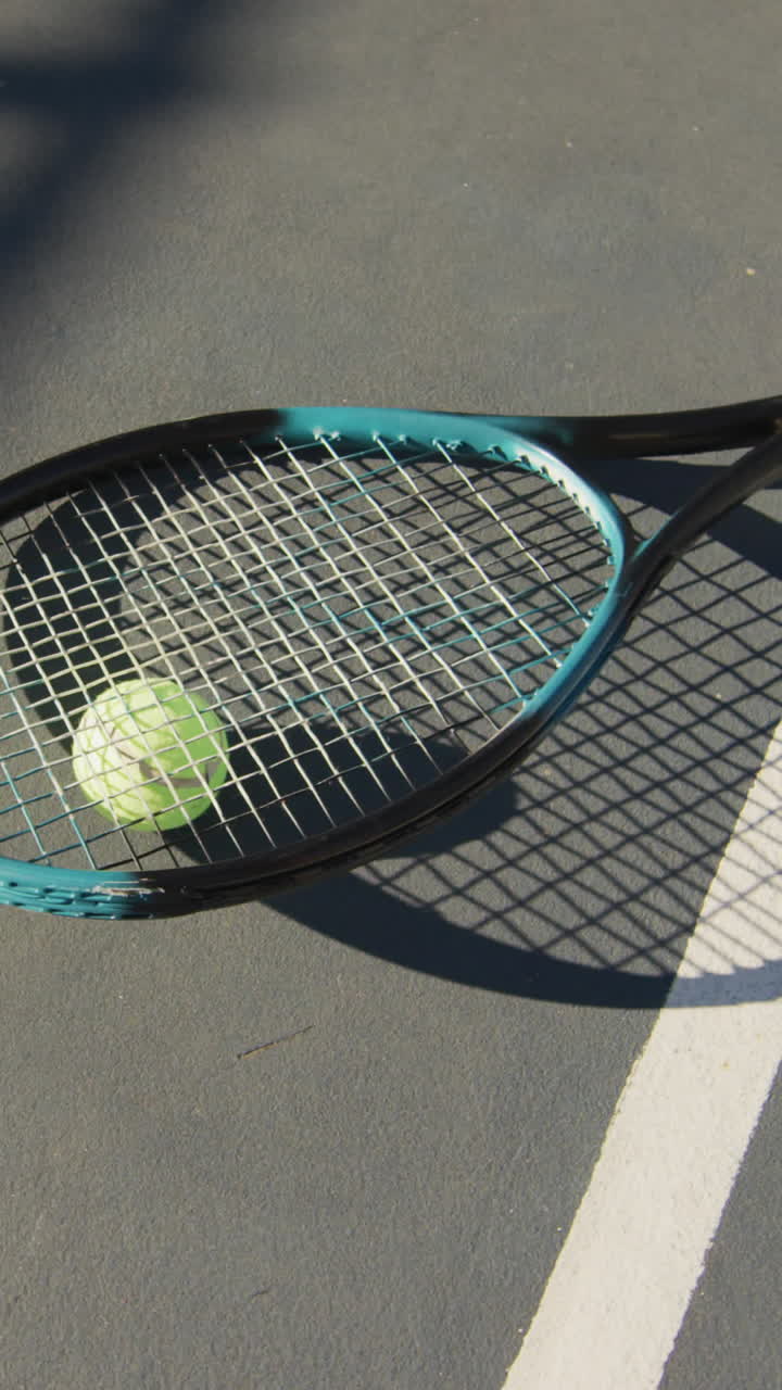 Video of tennis ball and racket lying on tennis court