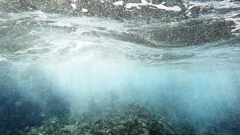 pov underwater diving shot showing beautiful coral reefs,rocks and water bubbles during sunlight