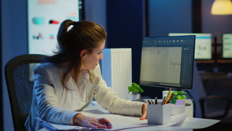 Overworked-woman-architect-analysing-and-matching-blueprints