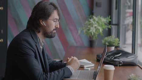 businessman having a video call in a cafe