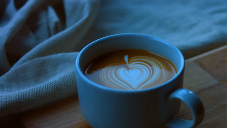 creating latte art with a heart design in a coffee mug
