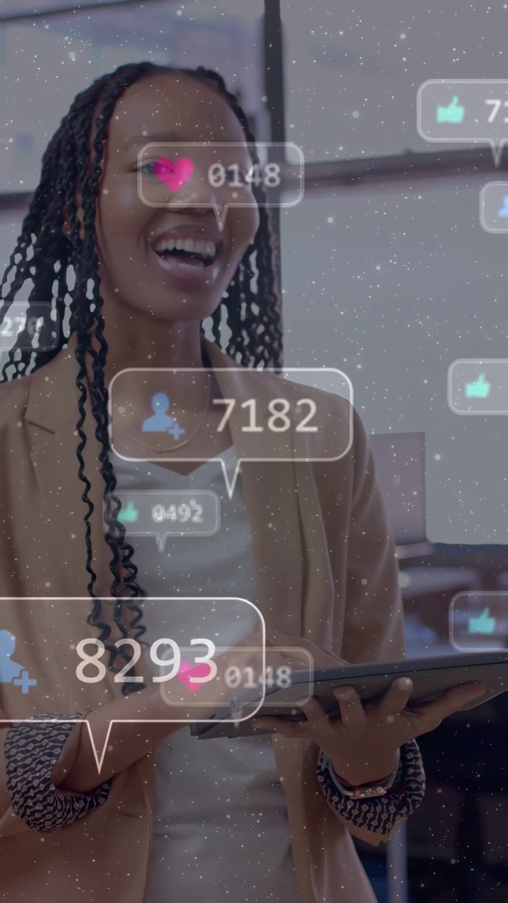 Vertical video: Woman in office tapping tablet showing social metrics updating while tracking ROI