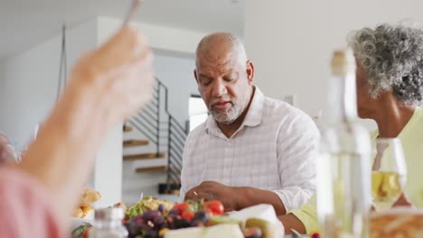 Happy-senior-diverse-people-having-dinner-at-retirement-home