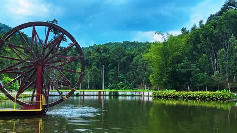 water wheel at the big fish pond at hoga gaharu tea valley in gopeng, perak, malaysia