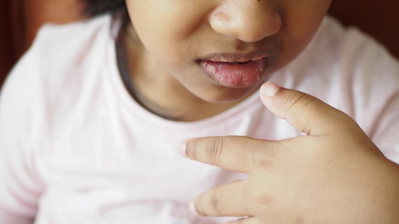 Close-up of a toddler girl sucking her thumb