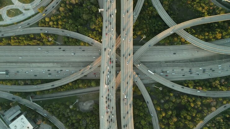 Drone top down view descends on traffic on looping freeway exchange in Houston Texas